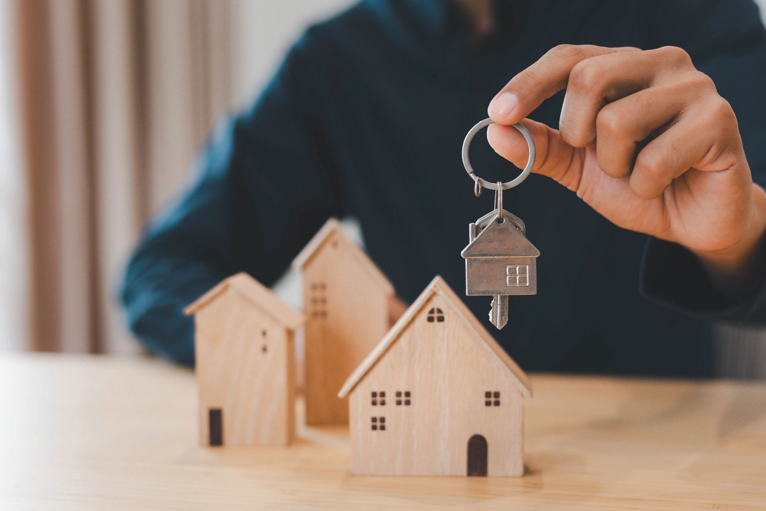 Real estate agent handing over house keys to new owners