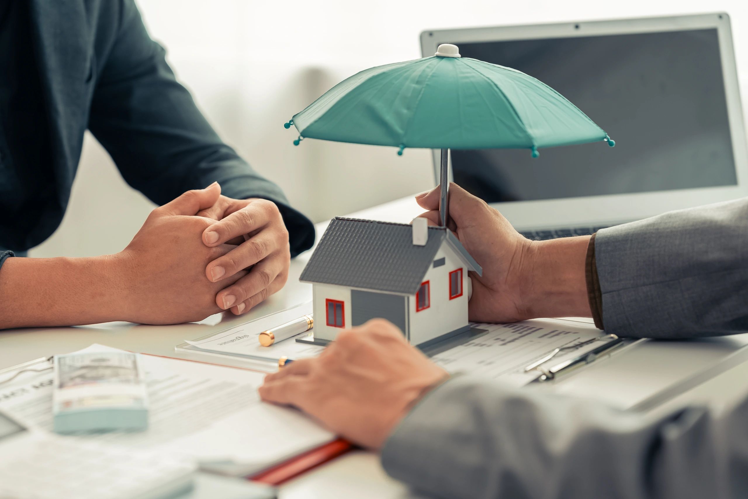 Home insurance agent holding umbrella